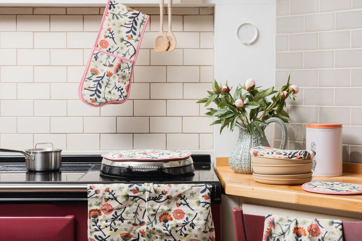 Raspberry red AGA in a kitchen with spring flower