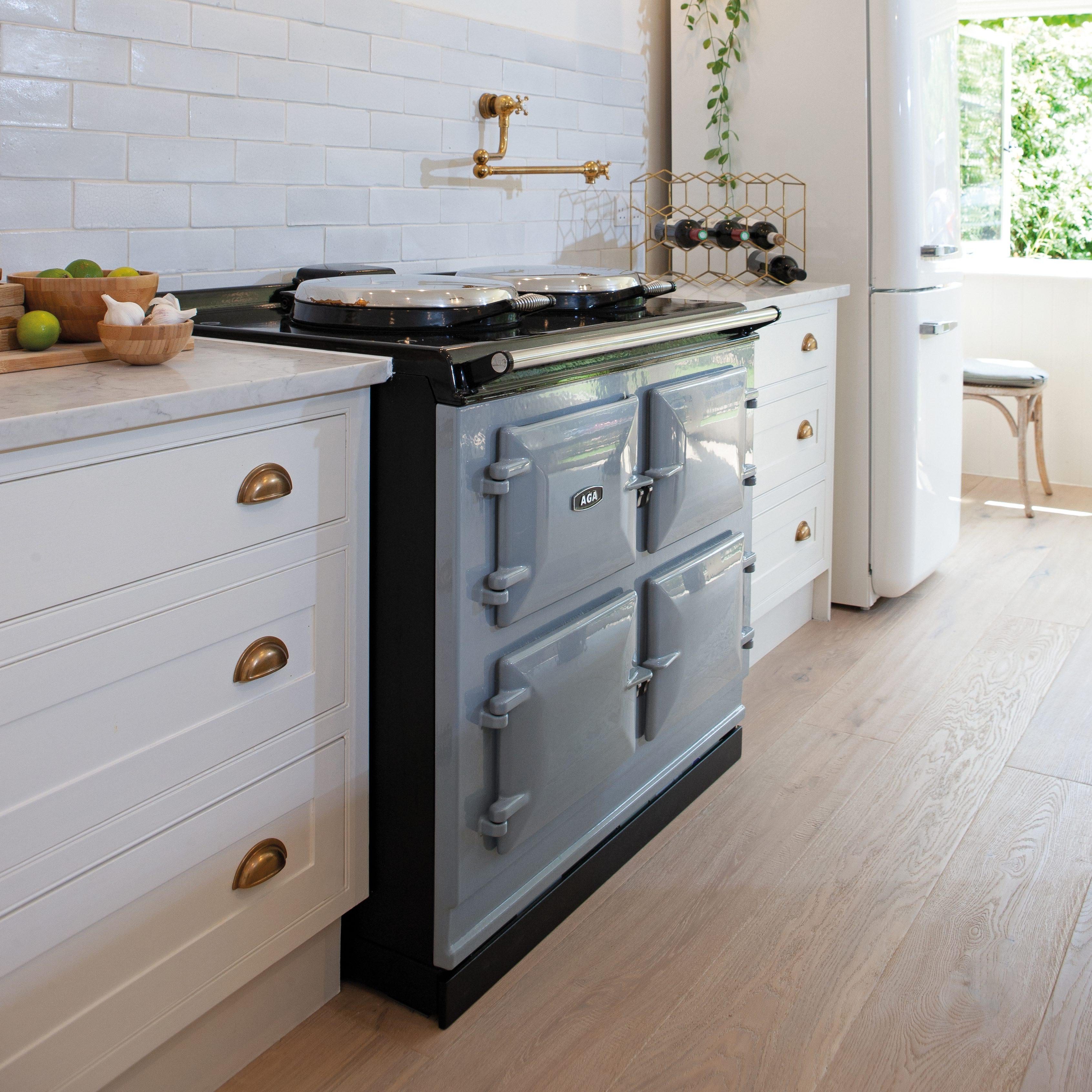 Dove grey AGA in a hand painted white kitchen with marble work surface and brass fittings